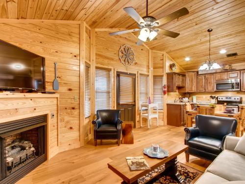 a living room with a fireplace in a log cabin at River Getaway #2326 in Pigeon Forge