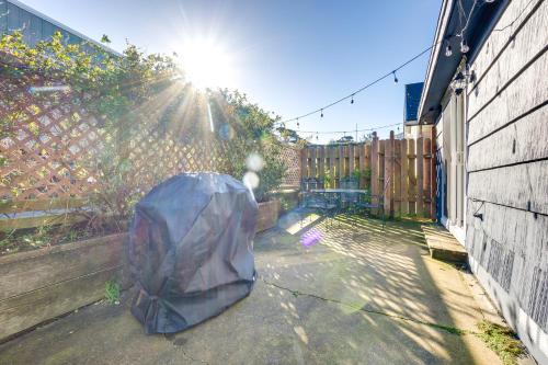 an umbrella sitting on the ground next to a fence at Bandon Beach House Rental Walk to Downtown! in Bandon
