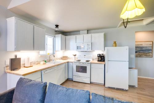 a kitchen with white cabinets and a white refrigerator at Bandon Beach House Rental Walk to Downtown! in Bandon