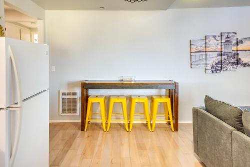 a kitchen with a table and two yellow stools at Bandon Beach House Rental Walk to Downtown! in Bandon