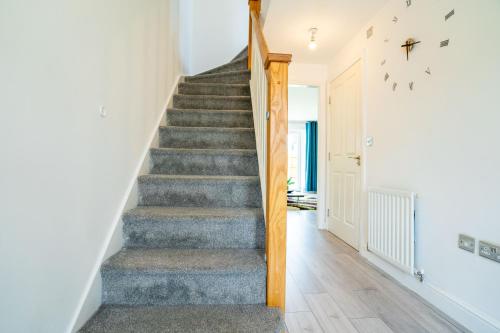 a staircase in a home with a blue carpet at Mulberry Garden in Coventry