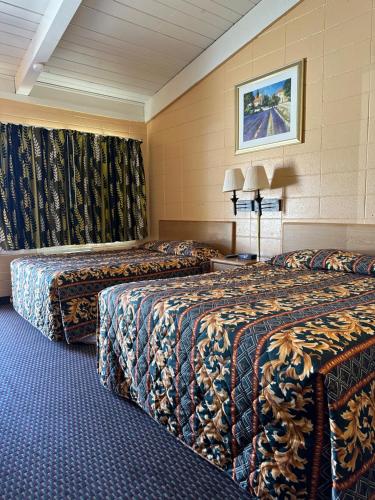 a hotel room with two beds in a room at Fireside Inn in King City
