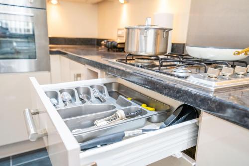 a kitchen with a sink and a stove at Mulberry Garden in Coventry