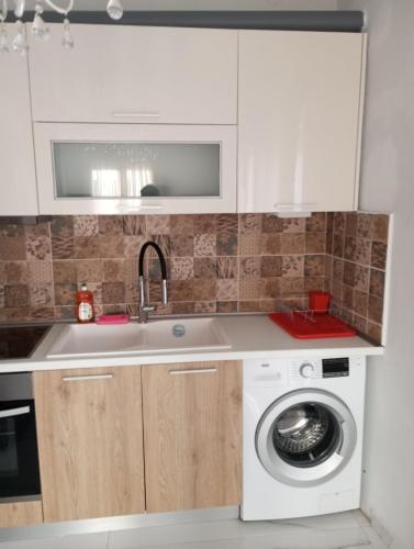 a kitchen with a sink and a washing machine at Studio Stesi Peraia Thessaloniki s in Perea