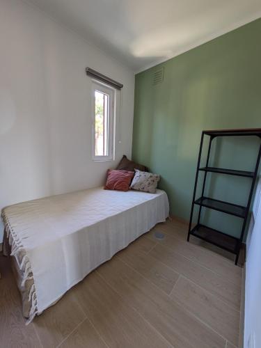 a bedroom with a white bed and a window at Private Lake Condo Apartment - Tróia in Troia