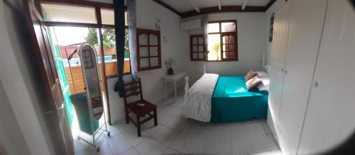 a small bedroom with a bed and a window at Sunbeachparadise in Port-Louis