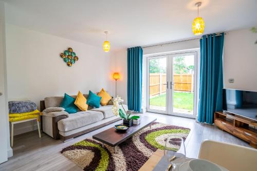 a living room with a couch and a tv at Mulberry Garden in Coventry