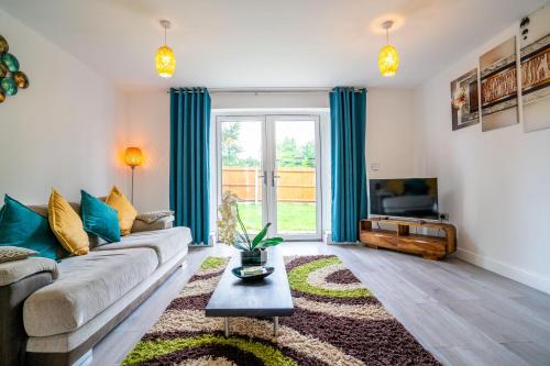a living room with a couch and a table at Mulberry Garden in Coventry