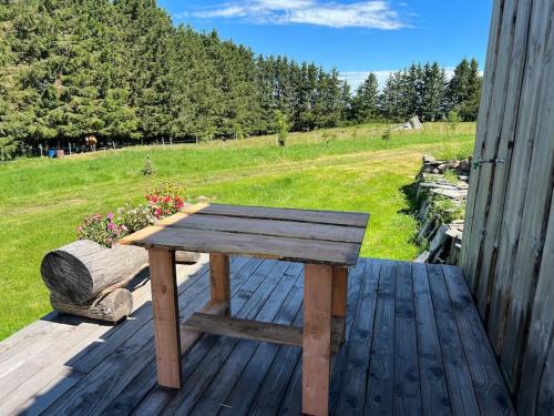 a wooden bench sitting on top of a wooden deck at La Petite Sibérie Nature Cadre exceptionnel in Mazet-Saint-Voy