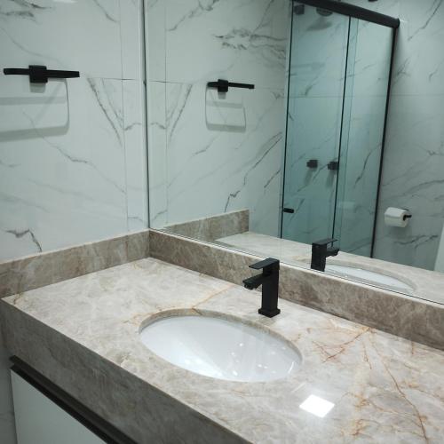 a bathroom with a sink and a glass shower at Eco Paradise 213 in Cumbuco