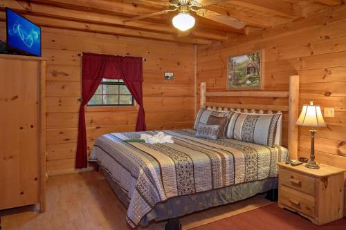 a bedroom with a bed in a log cabin at Wet Bear Paws #146 in Sevierville