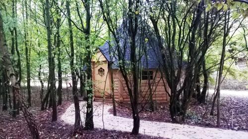 a small cabin in the woods with trees at Domaine De La Boulaie in Treize-Vents