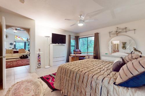 a bedroom with a large bed and a bathroom at Southwestern Sun Sanctuary in Sedona