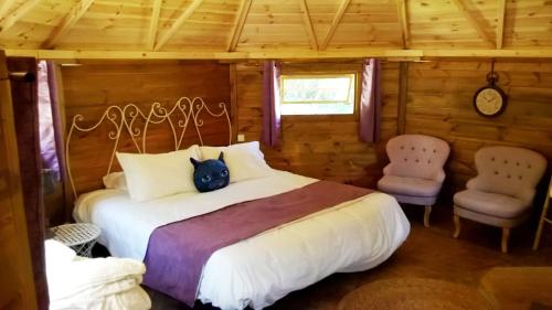 a bedroom with a large bed and two chairs at Domaine De La Boulaie in Treize-Vents