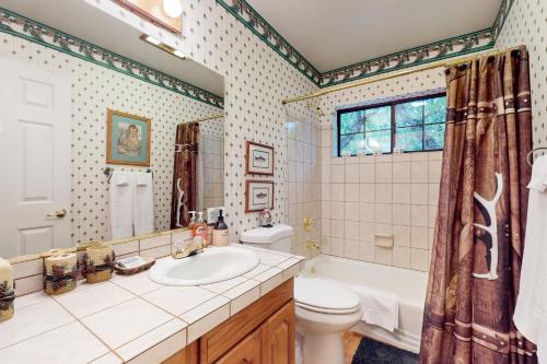 a bathroom with a sink and a toilet and a tub at Lakeside Livin' in Pinetop-Lakeside