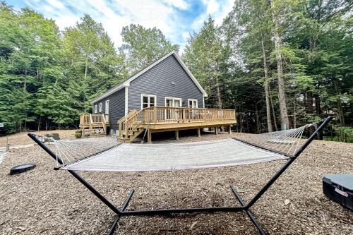 a hammock in front of a tiny house at Kenny's Kabin in Wolfeboro