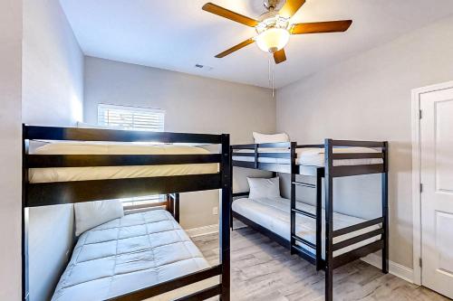 two bunk beds in a room with a ceiling fan at Old Bryan Salento - A in Myrtle Beach