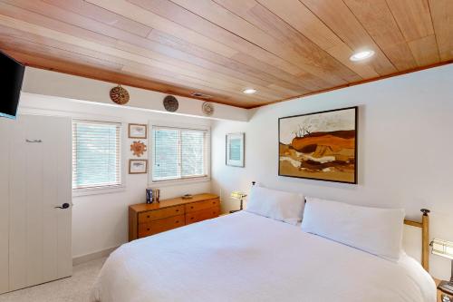 a bedroom with a white bed and wooden ceilings at Sun Valley Escape in Sun Valley