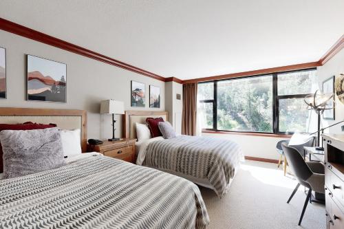 ein Hotelzimmer mit zwei Betten und einem Schreibtisch in der Unterkunft Everline Resort #241 & #243 in Olympic Valley