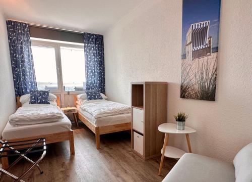 Ένα ή περισσότερα κρεβάτια σε δωμάτιο στο Frische-Brise-FeWo-15-03