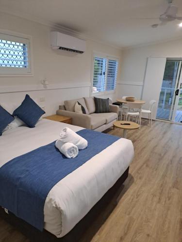 a bedroom with a bed and a living room at Cape Hillsborough Nature Tourist Park in Seaforth