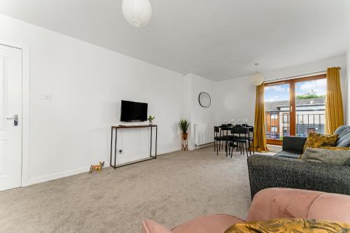 a living room with a couch and a dining room at 2Bed City Central East End Gem in Glasgow