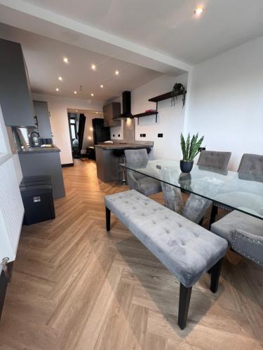 a living room with a dining table and a kitchen at The 145 house in Swansea city centre, Train, Beach, Mumbles, Gower in Swansea