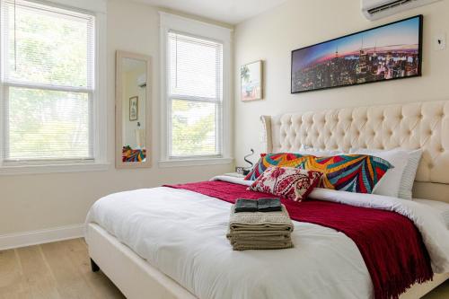 a bedroom with a large white bed and two windows at Renovated 5BR DC Home Naer Capitol Area Free Parking in Washington