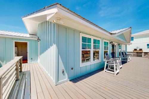 a large deck with chairs and a house at Kermit's Place in Fort Morgan