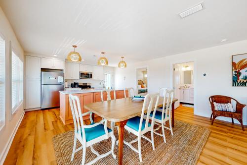 a kitchen and dining room with a wooden table and chairs at Kermit's Place in Fort Morgan