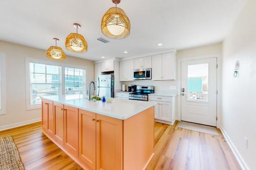 a kitchen with white cabinets and an orange island at Kermit's Place in Fort Morgan
