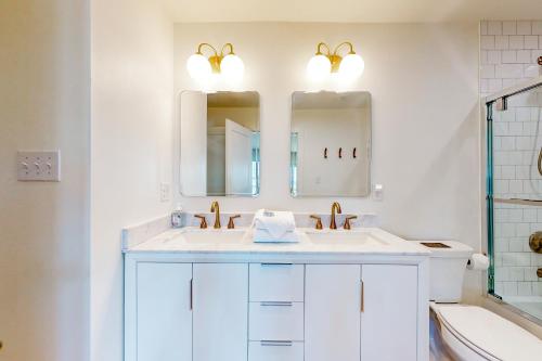 a bathroom with a sink and two mirrors at Kermit's Place in Fort Morgan