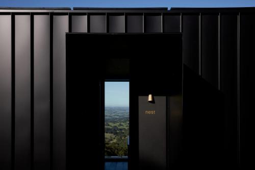 a black door with a sign that reads test at Nest & Nature in Inman Valley