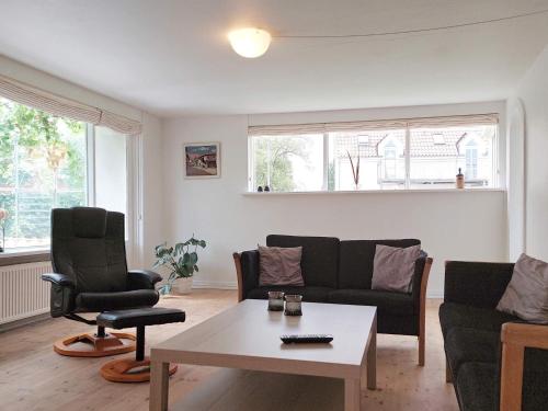 a living room with a couch and a table at 6 person holiday home in Ålbæk-By Traum in Ålbæk
