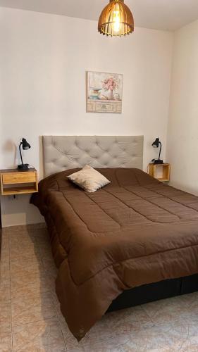 a bedroom with a large bed and two night stands at 760 B Apartamentos in Alta Gracia