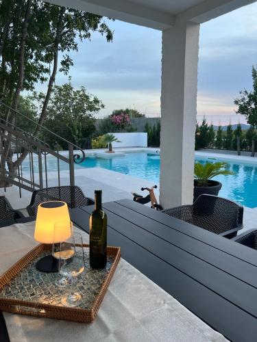 a table with a bottle of wine and a glass at Villa Hidden Heaven in Donje Vinovo