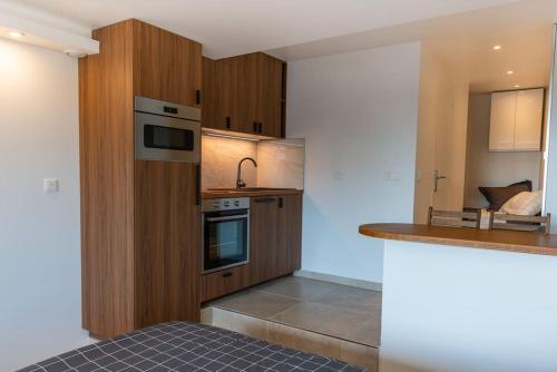 une cuisine avec des armoires en bois et un comptoir dans l'établissement Beau studio neuf, vue Marina, à Deauville
