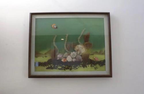 a framed picture of a painting on a wall at Casa Mar in Chelem
