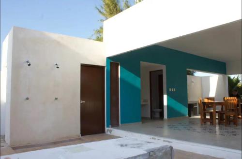 a house with a green and white wall at Casa Mar in Chelem