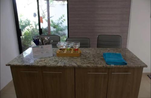 a counter with glasses and a box of fruit on it at Casa Mar in Chelem