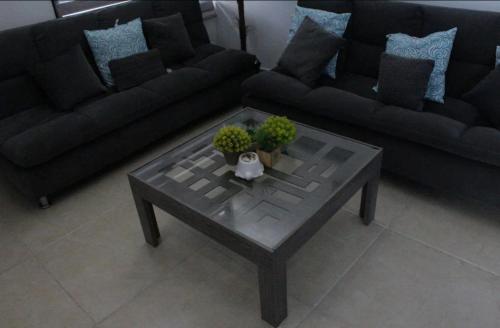 a living room with a couch and a coffee table at Casa Mar in Chelem