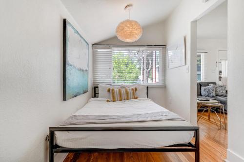 a bed in a room with a window at Vintage Tiny House CUTE 1BDRM Big Appeal in Colorado Springs