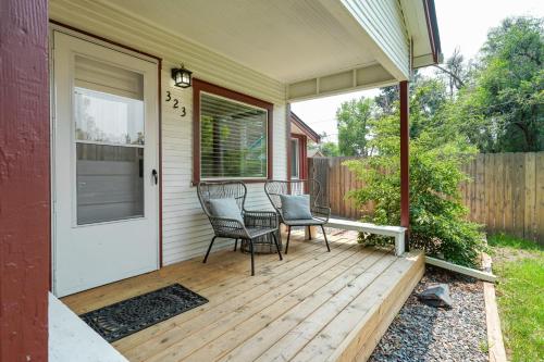 a porch with two chairs and a door on a house at Vintage Tiny House CUTE 1BDRM Big Appeal in Colorado Springs