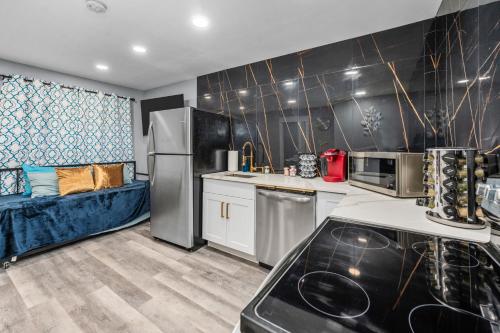 a kitchen with a refrigerator and a couch at Central Heights 2BR Oasis with Pool & Free Park in Houston
