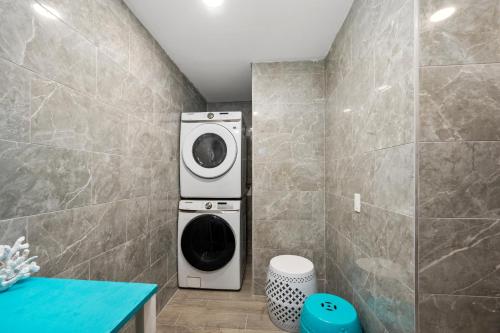 a washer and dryer in a bathroom at Central Heights 2BR Oasis with Pool & Free Park in Houston