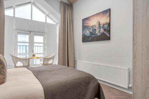 a bedroom with a bed and a large window at Thorsplan Luxury Apartment in Hafnarfjördur