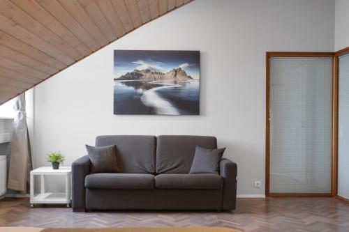 a living room with a couch and mountains in the water at Thorsplan Luxury Apartment in Hafnarfjördur