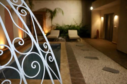 a group of white chairs sitting in a hallway at Villa Paradis in Marrakech