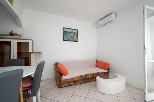 a living room with a couch and a table at Apartment Vidalici 6519f in Kustići