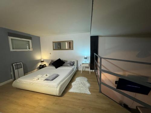 a bedroom with a white bed and a television at Madrid Loft duplex in Madrid